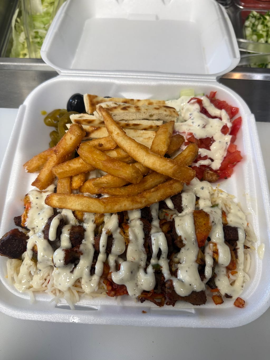 All in one plate with lamb, chicken, fries and salad
