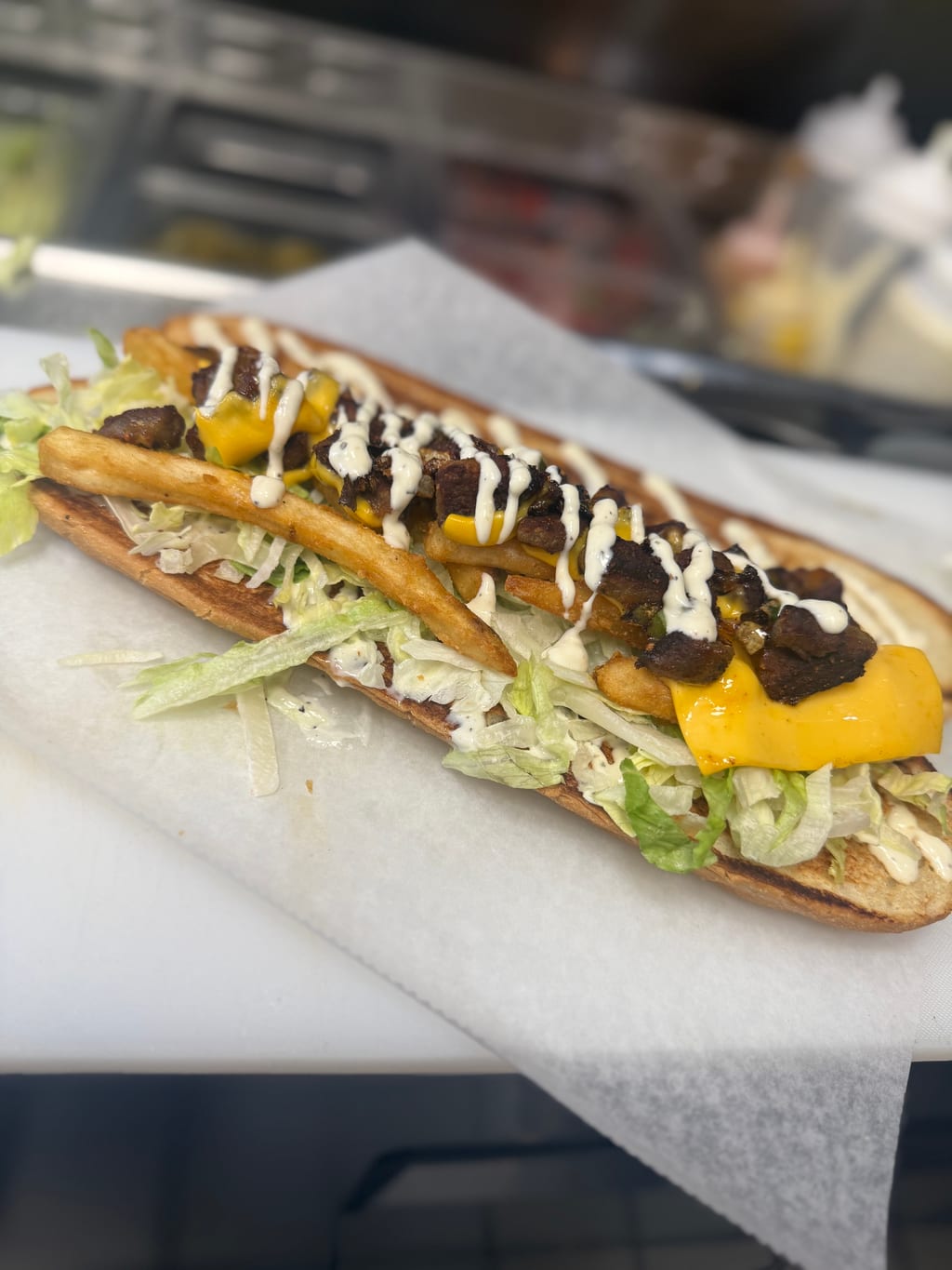Loaded lamb sandwich with fries and white sauce